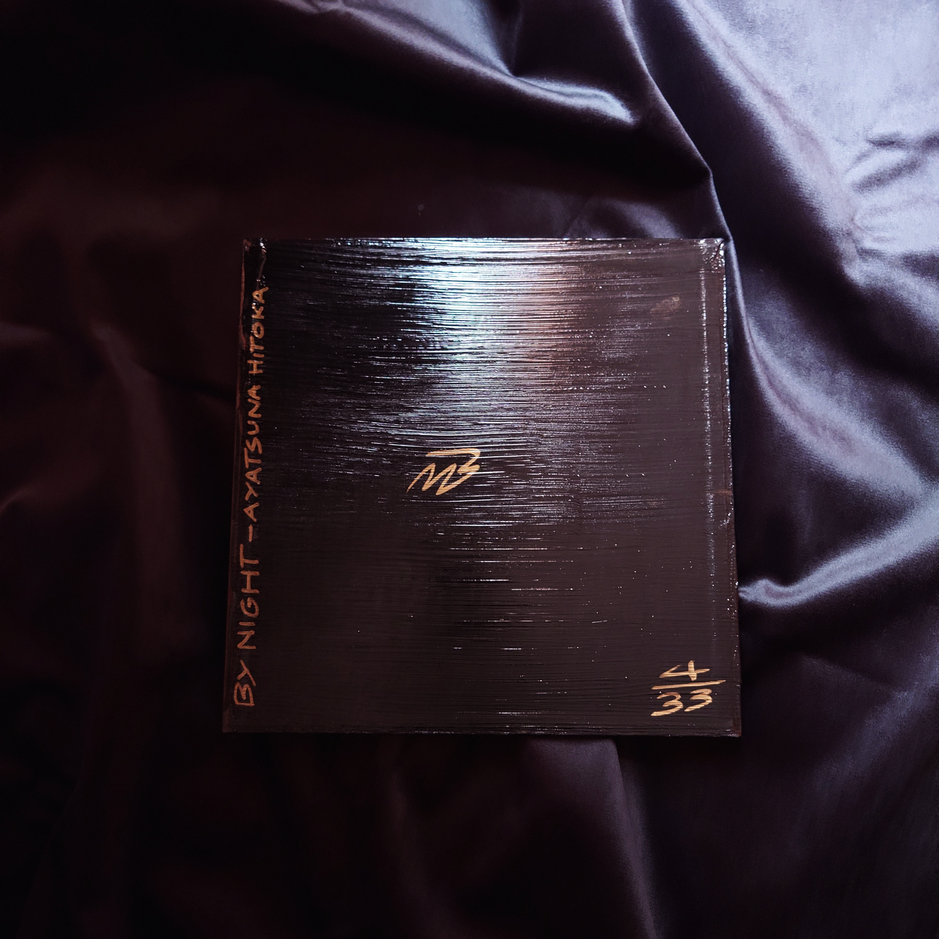 Ayatsuna Hitoka 絢繋 人華 BY NIGHT Acrylic Painting black and gold acrylic Japanese kanji painting - edition 4 laying flat on sheen black fabric